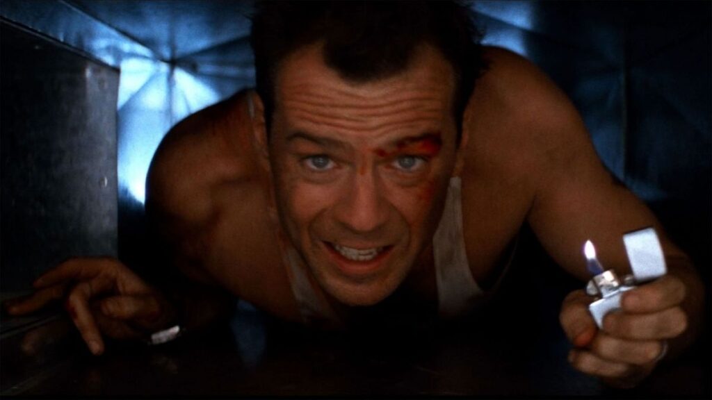 Melhores filmes de ação: 50 títulos imperdíveis para quem ama adrenalina 1 Bruce Willys em cena de Duro de Matar compondo a lista dos melhores filmes de ação