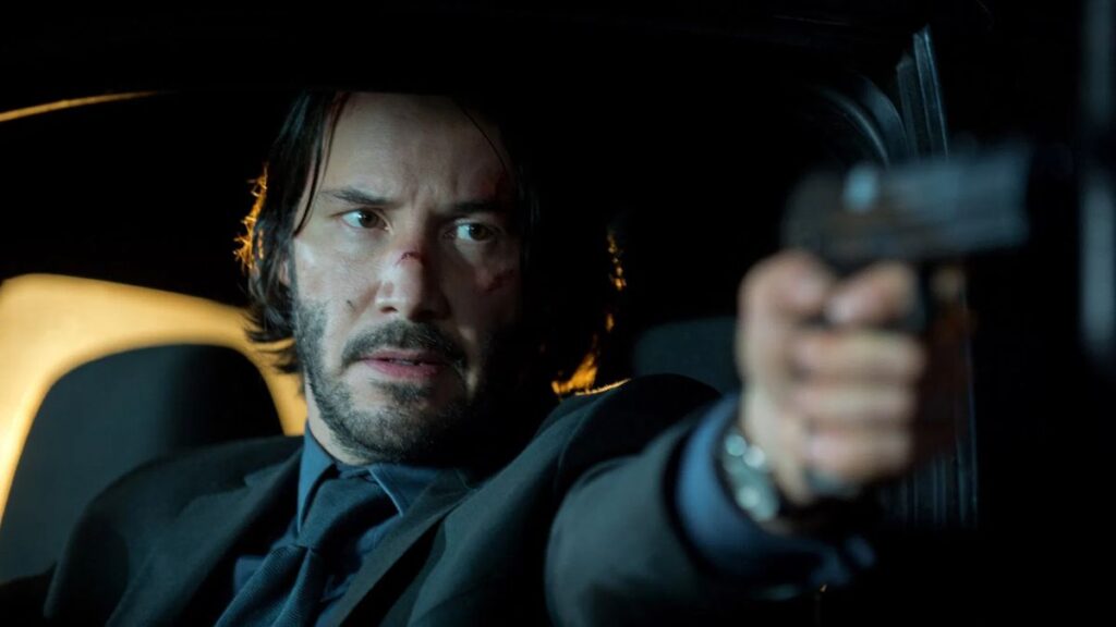 Melhores filmes de ação: 50 títulos imperdíveis para quem ama adrenalina 3 Keanu Reeves como John Wick em cena de filme compondo a lista de melhores filmes de ação